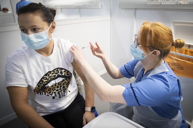 Nurse Eleanor Pinkerton administers a coronavirus vaccine to one of the health and social care staff at the NHS Louisa Jordan Hospital in Glasgow 