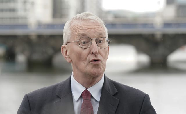 Northern Ireland Secretary Hilary Benn speaks to the media outside Waterfront Hall 