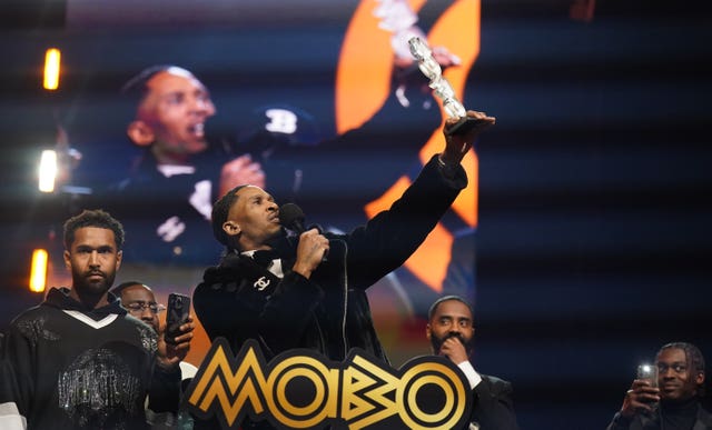 Scorcher celebrating winning best grime act at the Mobos