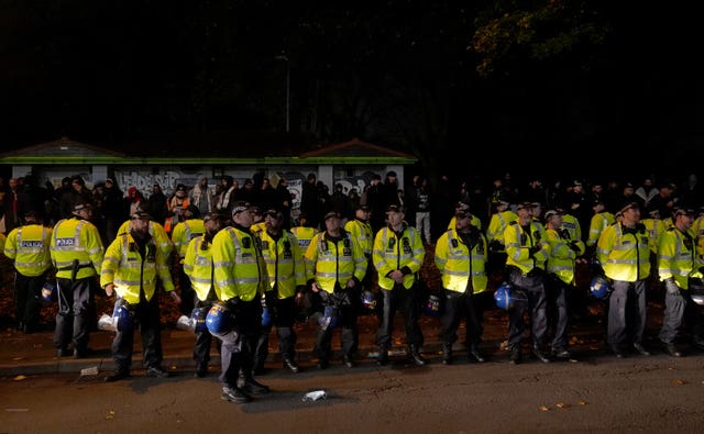 Police officers watch over pro-Palestine protesters outside Villa Park during the match in November 