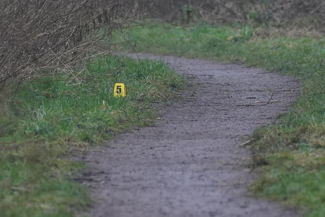 A yellow evidence marker at the scene of the incident