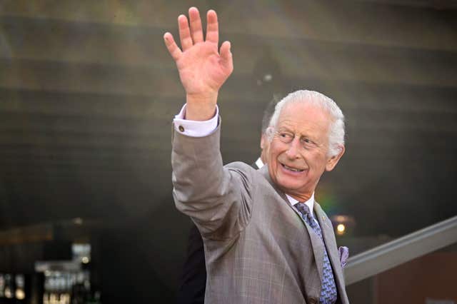 Charles waves at the crowds