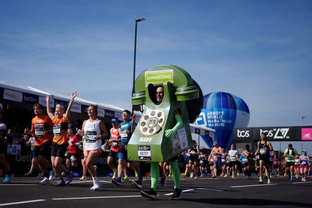 A runner dressed in a green telephone outfit 