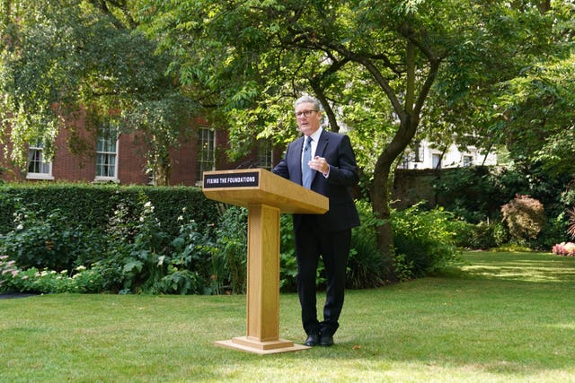 Sir Keir Starmer standing behind a podium with the words 'fixing the foundations' on it in the rose garden of 10 Downing Street