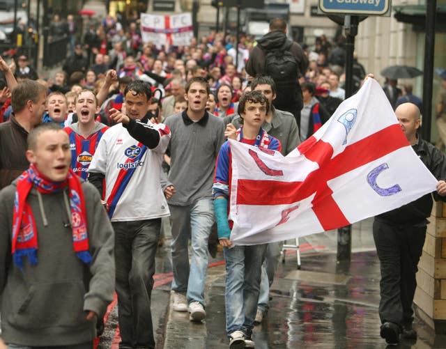 Crystal Palace fans celebrate near London Bridge following an announcement that the club is to be saved from extinction
