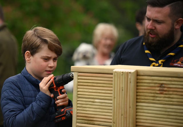 Prince George joins volunteers to help renovate and improve the 3rd Upton Scouts Hut in Slough, as part of the Big Help Out