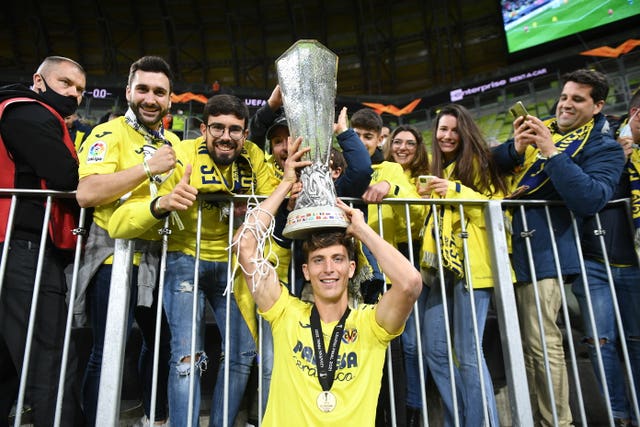 Villarreal's Pau Torres celebrates with the trophy and fans after the UEFA Europa League final