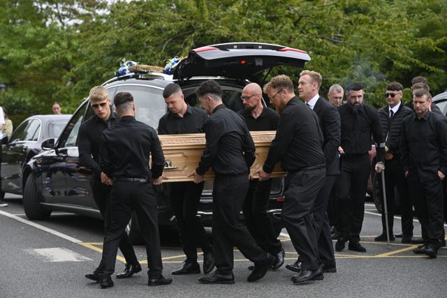 The coffin of Mark McCullagh-Crichton is carried into the Cathedral of Christ the King 