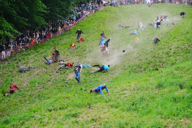 Participants take part in the annual cheese rolling at Cooper’s Hill in Brockworth, Gloucestershire
