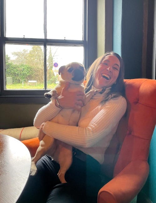 Handout photo of Amie Gray smiling while holding a dog