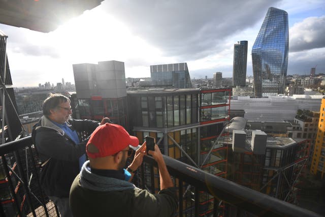 People take pictures from the viewing platform at Tate Modern