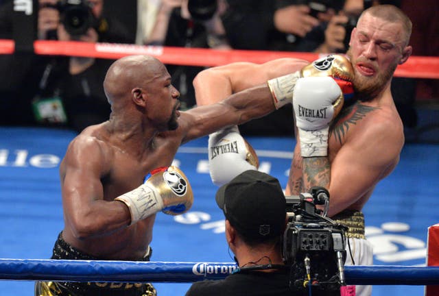 Conor McGregor, right, had a lucrative boxing showdown with Floyd Mayweather last year (PA)