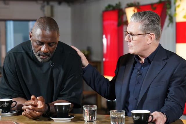 Labour leader Sir Keir Starmer rests his hand on the shoulder of actor Idris Elba