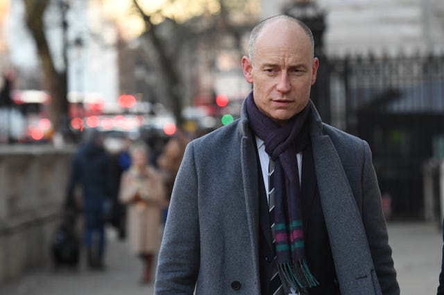 Care minister Stephen Kinnock walks down a street in London