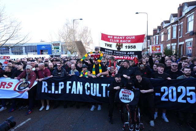 Manchester United fans march behind a banner reading R.I.P Fan Culture 1878-2025 in a protest against the club's ownership ahead of the Premier League match against Arsenal