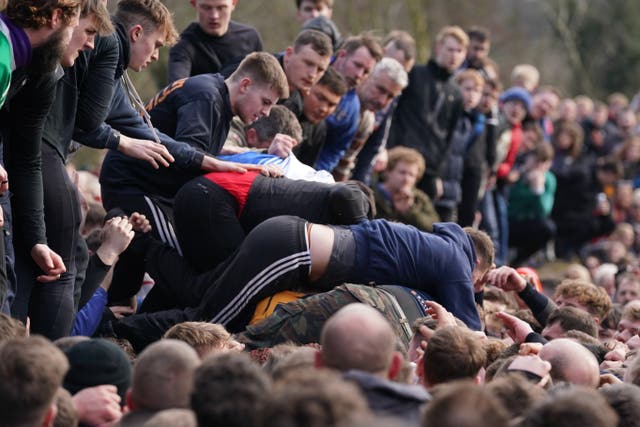 Players take part in the Royal Shrovetide Football Match in Ashbourne, Derbyshire, which has been played in the town since the 12th century