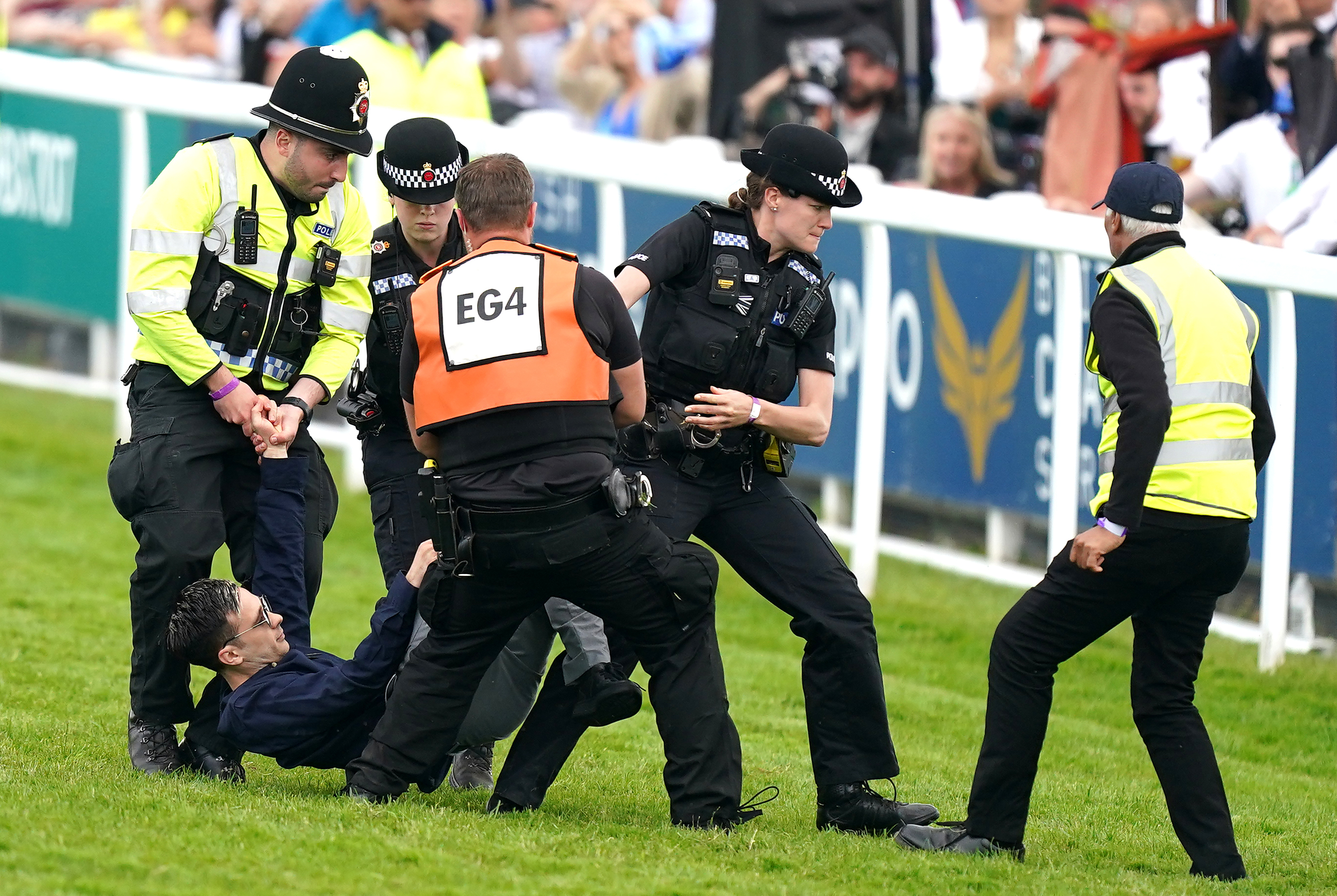 A protester is arrested at Epsom