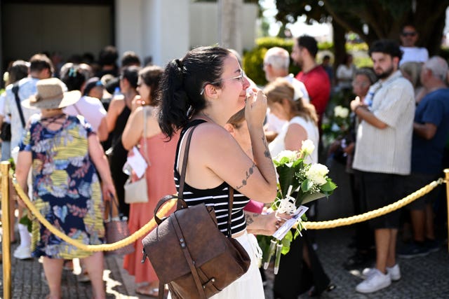 Mourners pay their respects at the wake of Diogo Jota. 