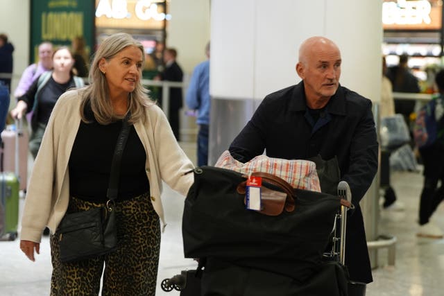 Barry McGuigan and his wife Sandra arrive at Heathrow airport 