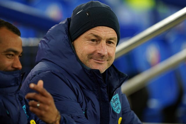 Lee Carsley sitting in the England Under-21 dugout