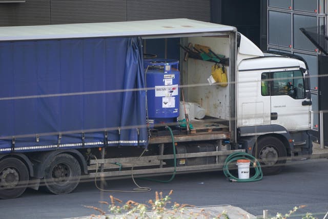 A lorry carrying a tank of hydrochloric acid, parked outside the Aquatics Centre