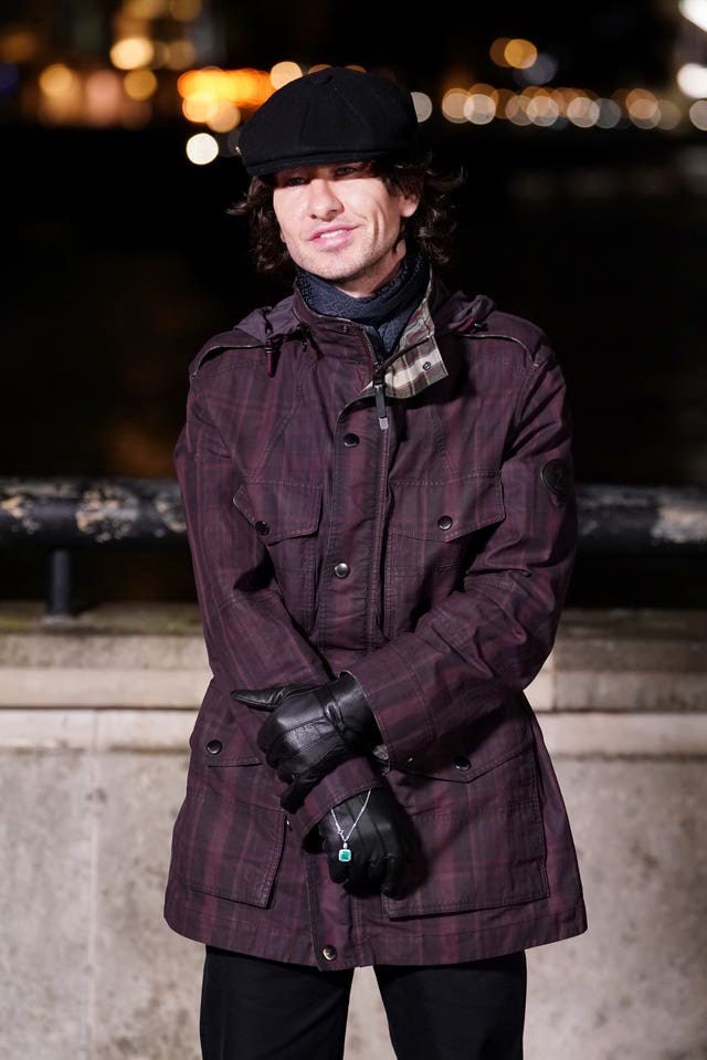 Barry Keoghan in a burgundy checked coat and baker boy cap