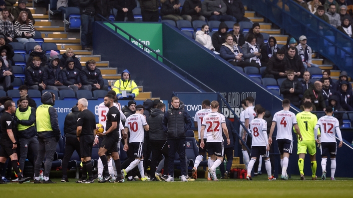 Players leave the pitch after the match was halted due to a medical condition (Richard Sellers/PA)