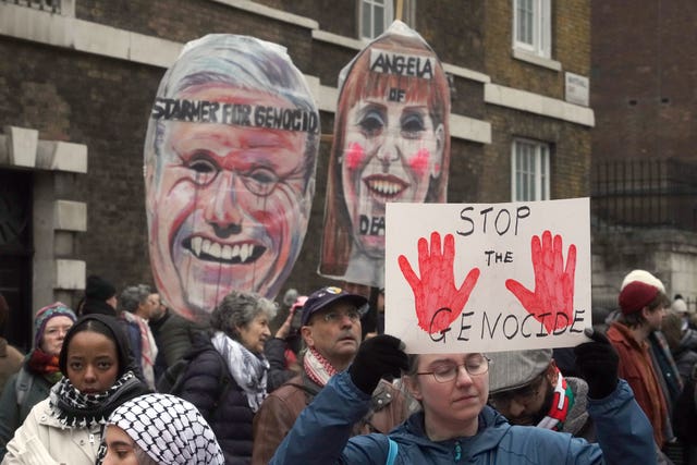 Protesters holding banners at pro-Palestine rally