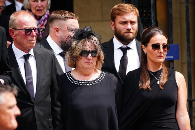 The family of Mr Henderson pay their respects outside Truro Cathedral (Ben Birchall/PA)