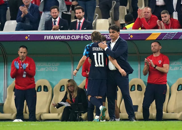 Luka Modric is greeted by manager Zlatko Dalic as he is substituted off