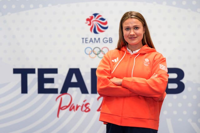 Lola Anderson poses in front of a Team GB sign. 