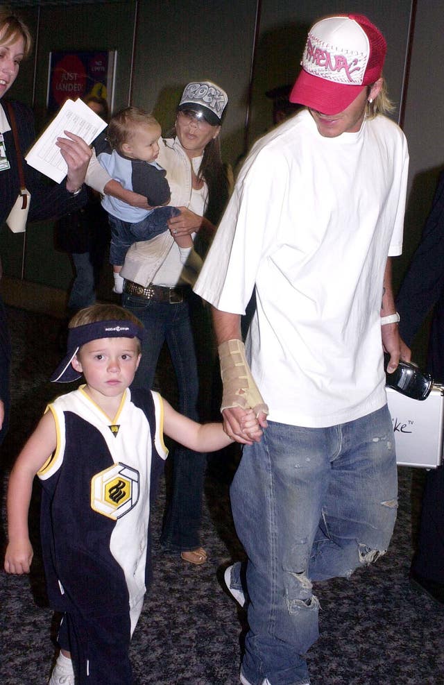 David Beckham holding Brooklyn's hand at Heathrow Airport