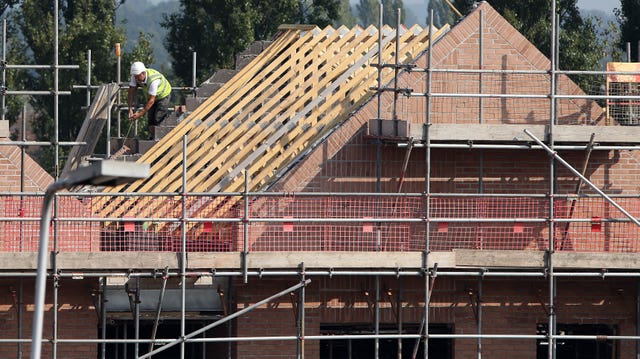 Workers at a construction site for new homes