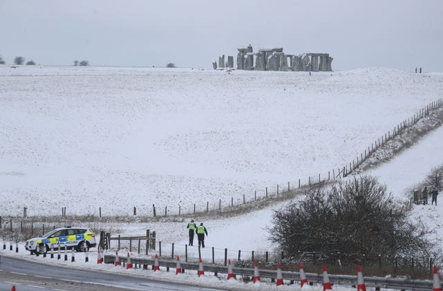 Police at a snowy Stonehenge in Wiltshire 