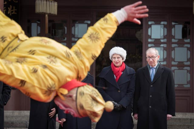 Theresa and Philip watch a Chinese opera acrobat at the Yellow Crane Tower in Wuhan (Stefan Rousseau/PA)