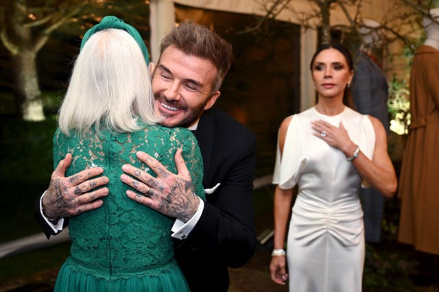 David Beckham hugs Dame Helen Mirren as his wife Victoria watches  