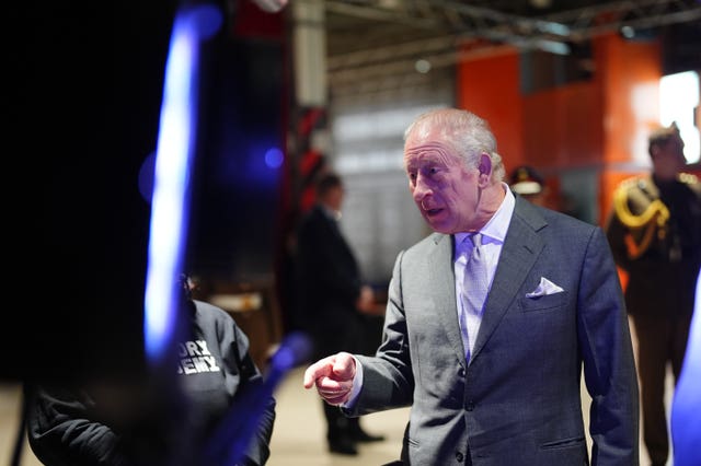 Charles watches a production being put together for a live music event