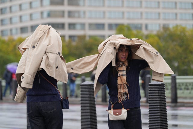 People shelter from the rain