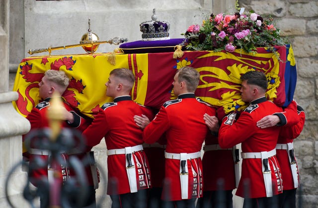 The coffin of Queen Elizabeth II being carried by pallbearers at the State Funeral held at Westminster Abbey