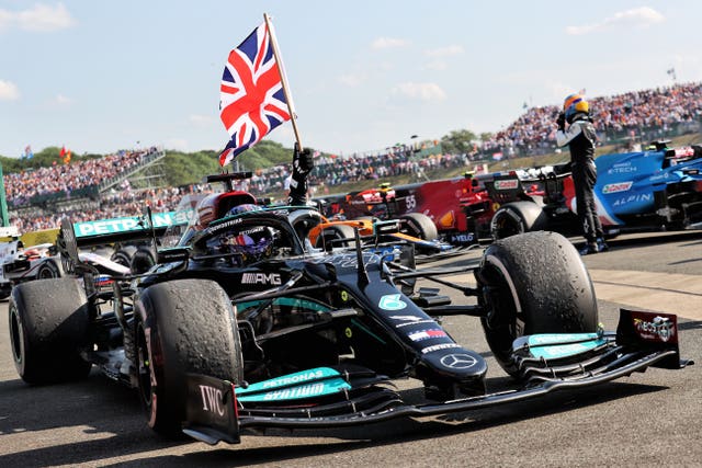Lewis Hamilton flies the British flag after winning at Silverstone this year