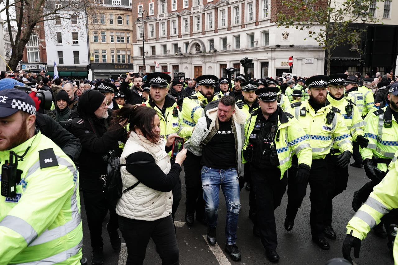 Tommy Robinson escorted from march against antisemitism as man arrested