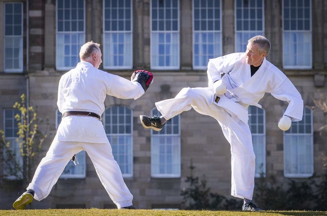 Willie Rennie (right) takes part in a karate lesson with Robert Steggles at The Meadows, Edinburgh, during campaigning