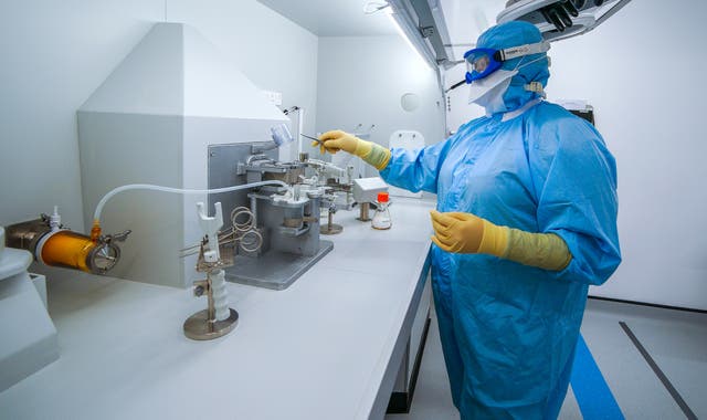 Staff work inside the AstraZeneca Laboratory in Macclesfield