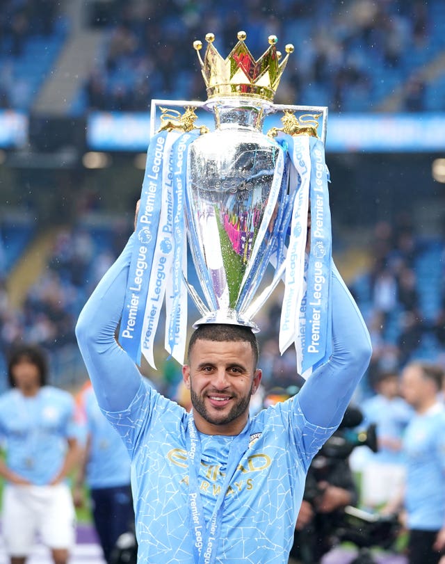 Manchester City’s Kyle Walker lifts up the Premier League trophy to celebrate a title win