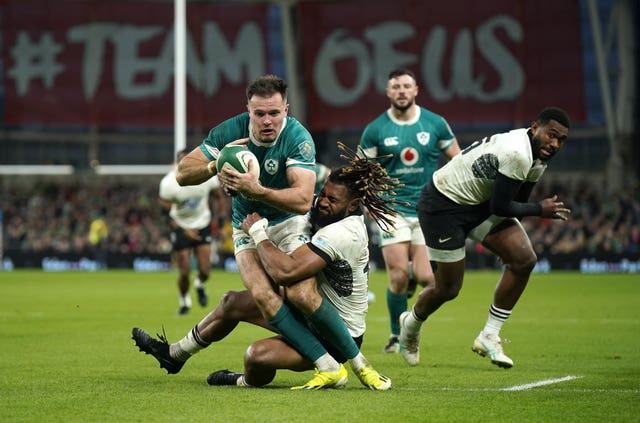 Ireland wing Jacob Stockdale is tackled by Fiji’s Waisea Nayacalevu