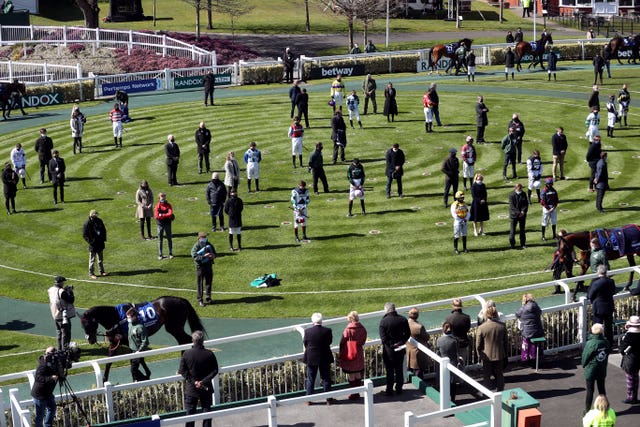 Jockeys and owners in the parade ring observe a silence in honour of the Duke of Edinburgh