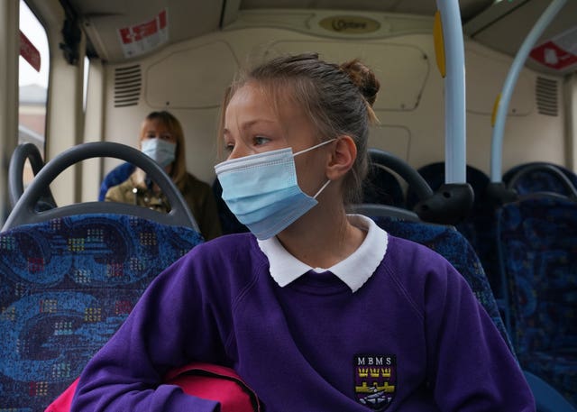 (Permission granted) A school pupil wearing a face mask on a bus in Newcastle (Owen Humphreys/PA)