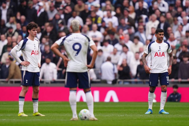 Cristian Romero (right), Richarlison and Archie Gray appear dejected after Forest's second goal