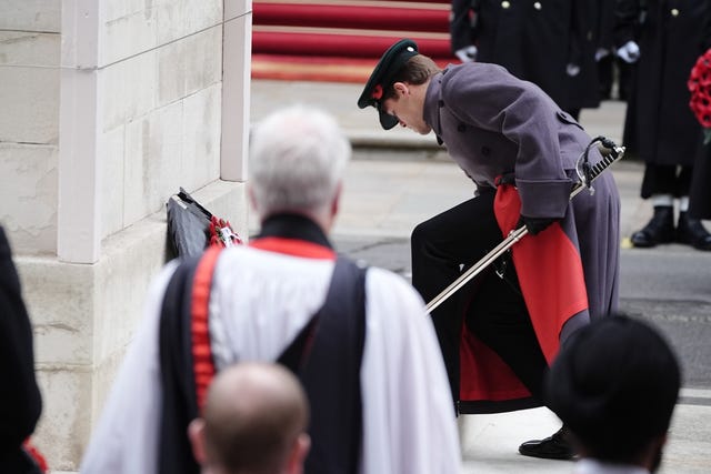 The Queen's equerry Major Ollie Plunket lays her wreath during the Remembrance Sunday service at the Cenotaph