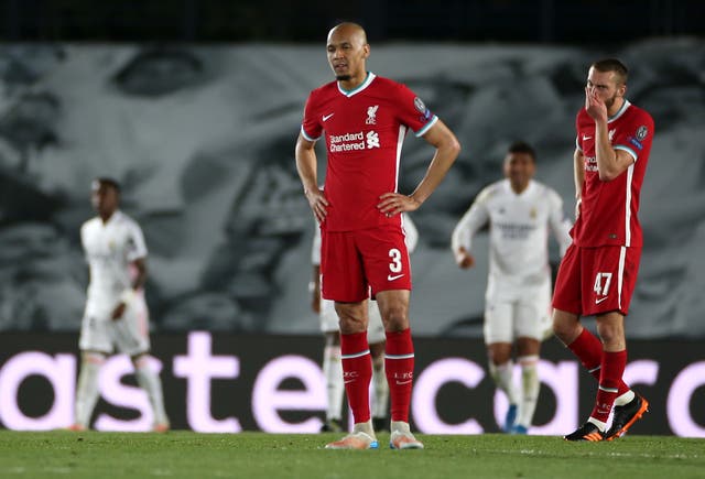 Liverpool's Fabinho and Nat Phillips look despondent after conceding a third goal to Real Madrid